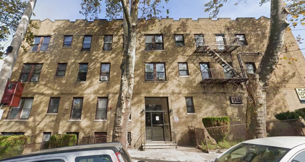 Three-story brick apartment building at 140 Carlton Avenue in the Jersey City mixed-use property sale