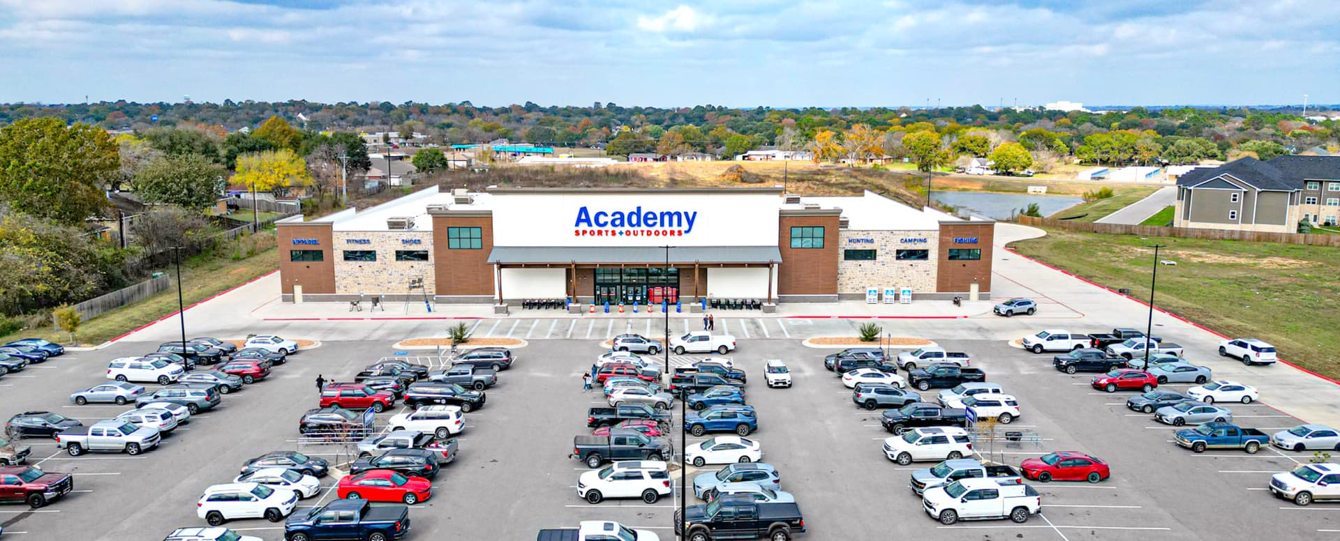 Aerial view of the Academy Sports + Outdoors storefront and parking lot in Brenham, Texas, subject of the Academy Sports + Outdoors disposition