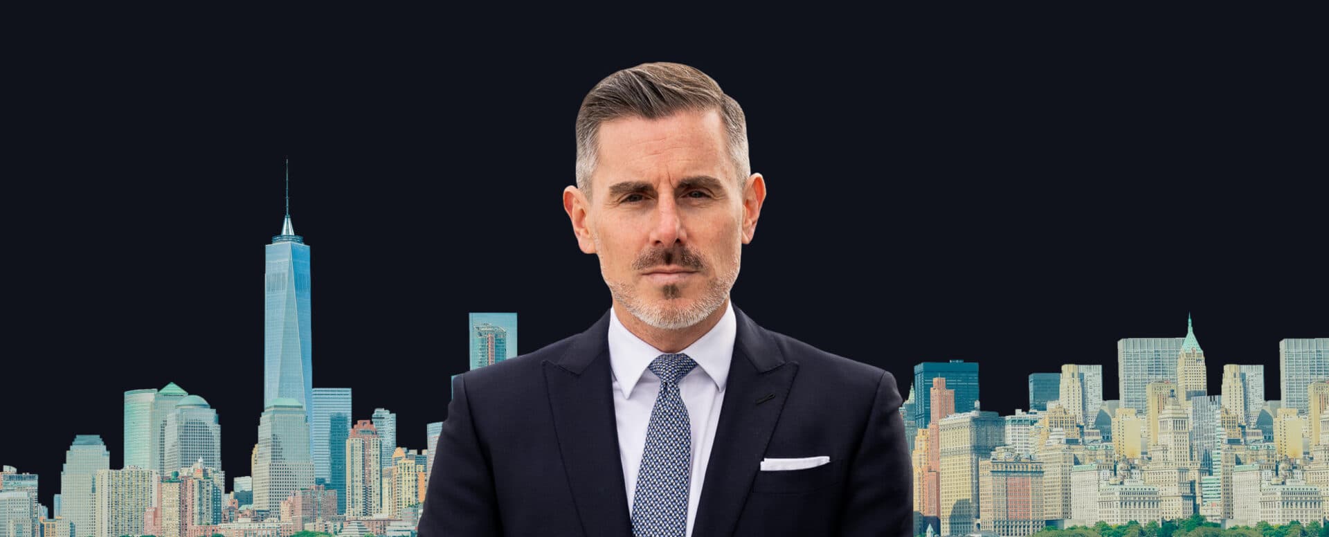 Man in a navy suit in front of the New York City skyline representing Matthews New York expansion