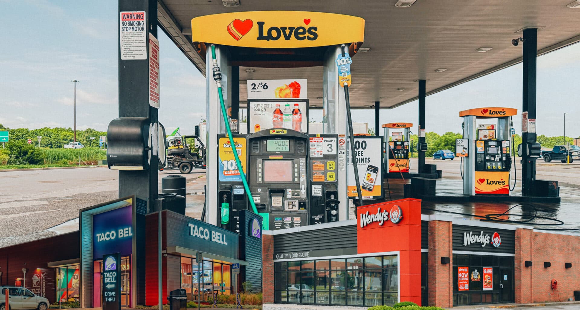 Roadside retail strip with a Love's fuel station, Taco Bell and Wendy's illustrating Midwest gas prices and QSR traffic
